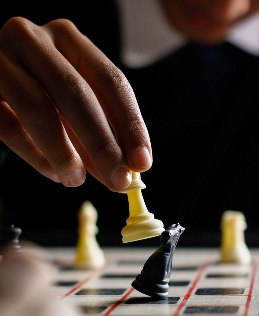 A white chess piece taking a black piece